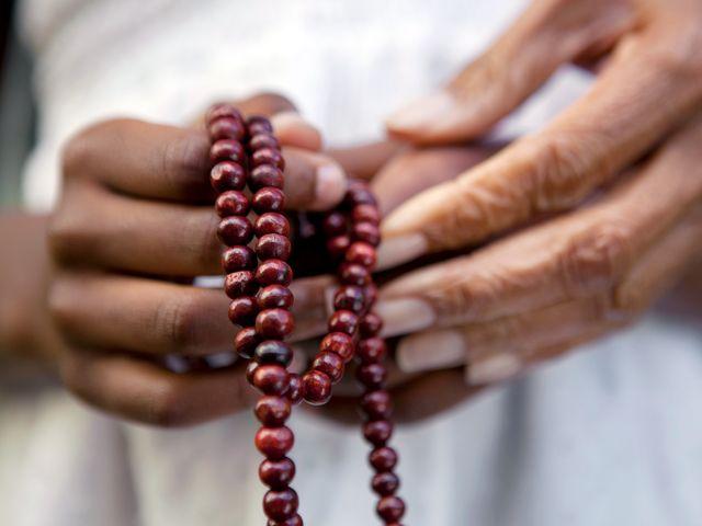 Hands holding rosary beads